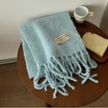 Light blue fuzzy wool scarf with tassels and decorative woven label detail - Light Blue