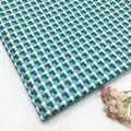Premium blue and teal woven cotton linen jacquard fabric with a fish scale pattern design - Lake Blue