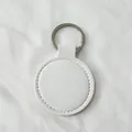 Porte-clés rond minimaliste en similicuir blanc avec anneau fendu en métal argenté - Blanc