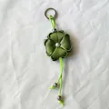 Handmade olive green ribbon flower keychain with four-leaf clover design and pearl bead - Green