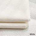 Close-up of premium solid white gold thread chenille fabric for sofas and pillows - White