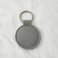Elegant grey round PU leather keychain pendant with a durable silver metal ring - Gray