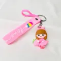 Detailed view of cute soft rubber girl keychain with peach and Love wrist strap - Pink