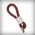 Close-up view of a premium burgundy braided leather car keychain with silver metal clasp. - Universal Model / Dark Red