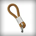 Detailed view of a brown braided leather keychain with a polished silver metal clasp. - Universal Model / Light Brown