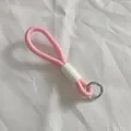 Close-up view of a pink braided lanyard featuring a white rubber grip and silver metal ring - Pink and White Style (2)
