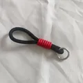 Close-up view of black braided rope lanyard with red sleeve and metal spring ring - Black and Red Style (4)