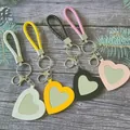 Porte-clés miroir de maquillage en forme de cœur avec lanière en cuir tressé coloré - Couleurs Mixtes