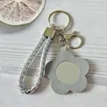Porte-clés élégant en corde tressée argentée avec miroir fleur en similicuir gris - Gris