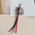 Portachiavi fatto a mano con nappa a cuore e cordoncini di cera intrecciati rossi e neri - Nero rosso