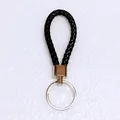 Close-up of a premium black braided leather keychain featuring a polished silver split ring - 50 Pieces/Pack / Black