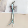 Portachiavi con nappa in corda cerata intrecciata azzurra e bianca con ciondolo a cuore d'argento - bianco-blu