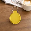 Minimalist round PU leather keychain in vibrant yellow finish - Yellow