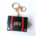 Stylish vintage leather mini bag keychain with red stripes and polished gold hardware - Black