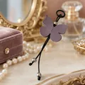 Elegant mauve butterfly PU leather keychain with silver beads on a vanity setting. - Deep purple