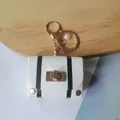 Vintage white leather mini bag keychain with black stripes and elegant pearl charm - White