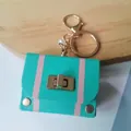 Retro mint green leather bag keychain with gold-tone hardware and pearl charm - Teal