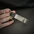 Λεπτομέρεια μάκρο του χρυσού 'GOOD LUCK' κειμένου σε διαφανές λουράκι για μπρελόκ τσάντας - Σχέδιο Με Μήνυμα Τύχης (GOOD LUCK) / Διαφανές Λουρί (Στυλ 1)