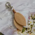 Detailed view of beige suede leaf keychain with sturdy silver metal lobster clasp. - Light Coffee