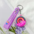 Primer plano de llavero de dona de silicona morada con arcoíris y correa I LOVE YOU - Púrpura