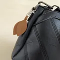 Fashionable brown faux suede leaf keychain charm on a black textured leather bag - Dark Coffee
