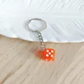 Orange acrylic dice keychain featuring a silver metal ring for bags and car key accessories - Orange