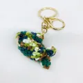 Macro shot of a handmade colorful crochet fish keychain with gold hardware on white. - Knitted Ocean Animal Style 2 (Pendant-2)