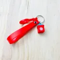Detailed macro view of a red silicone Christmas keychain with a snowflake gift box charm - Gift Box