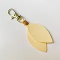 Elegant cream-colored velvet leaf keychain with silver lobster clasp for bags and keys. - Light Yellow