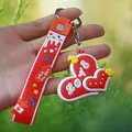 Vue détaillée d'un porte-clés cœur en silicone 3D avec une lanière orange texturée - Sangle Cœur Rouge