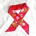 Detailed view of red Christmas skinny scarf with Santa and gift patterns for bags. - Christmas Scarf 4