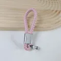 Stylish pink braided PU leather car keychain with a silver horseshoe buckle accessory - Pink