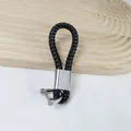 Premium black braided PU leather keychain with a stylish silver horseshoe buckle variant - Black