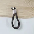 Brown braided PU leather car keychain featuring a durable silver metal horseshoe buckle - Dark Coffee