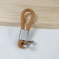 Handcrafted tan brown PU leather woven keychain with a polished silver horseshoe buckle - Light Coffee