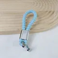 Light blue braided leather keychain with silver horseshoe buckle and metallic connector - Light Blue