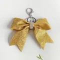 Elegante portachiavi con fiocco dorato glitterato e strass per decorazioni natalizie - Giallo