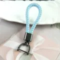 Close-up of light blue braided leather keychain with gunmetal grey horseshoe shackle. - Light Blue