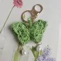Delicate handmade green crocheted butterfly keychain with pearl accents for stylish bag charm - Green