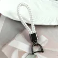 Braided white faux leather strap keychain with gunmetal black horseshoe D-ring buckle - White