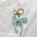 Handmade light blue crocheted yarn bow keychain with pearl bead for bag accessory - Light Blue