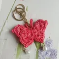 Hand-knitted 3D butterfly keychain in magenta with pearl pendants for bag charm - Rose Red