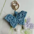 Handmade blue crochet butterfly keychain with pearl drops for cute bag decoration - Denim Blue