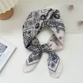 Detailed macro view of a vintage navy paisley silk square scarf on white surface - Paisley Four Grid Beige