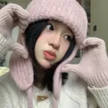 Pink knitted aviator hat with earflaps shown on model for autumn and winter warmth - One Size / Pink