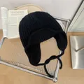 Black chunky knit trapper hat with ear flaps and chin straps for winter outdoor skiing - One Size / Black