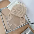 Cozy beige knitted earflap hat with ties for autumn and winter outdoor warmth - One Size / Khaki