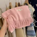 Soft pink chunky knitted scarf with long tassels and a minimalist decorative brand label - Baby Pink / 194cm