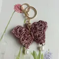 Handmade wine red crocheted butterfly keychain accessory featuring elegant pearl drops - Dark Purple