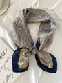 Detailed view of paisley pattern silk scarf elegantly tied on a white shirt background - 70cm / Aesthetic Tar - Champagne